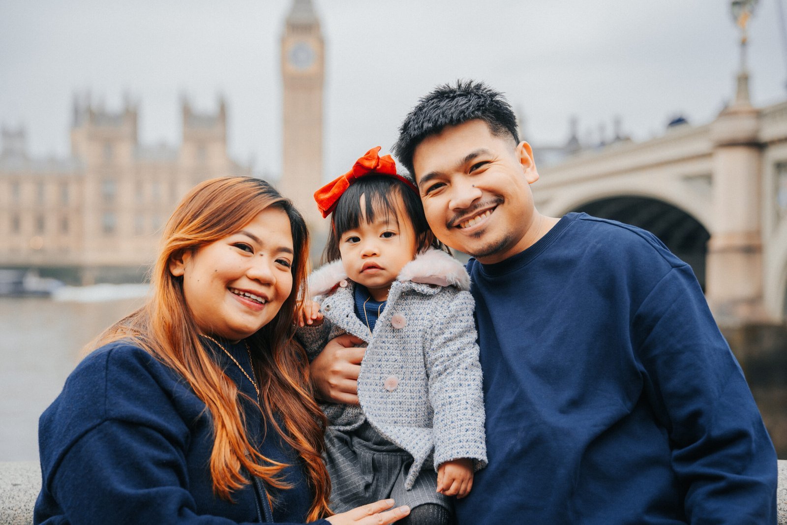 Family dressed in coordinated blue and grey tones during a London portrait session